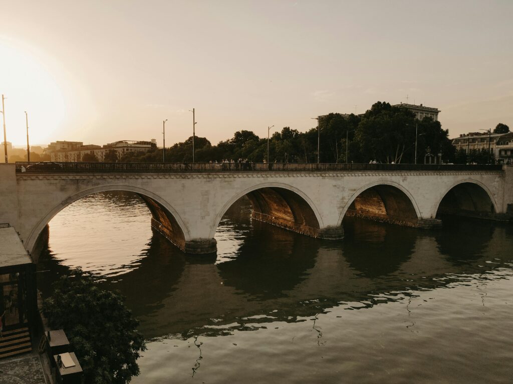 A serene sunset view of Saarbrucken bridge over the Kura River in Tbilisi, Georgia.